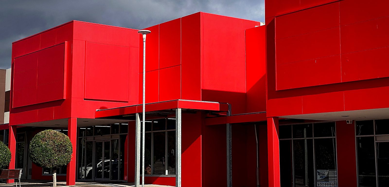 Completed commercial repaint — red feature façade