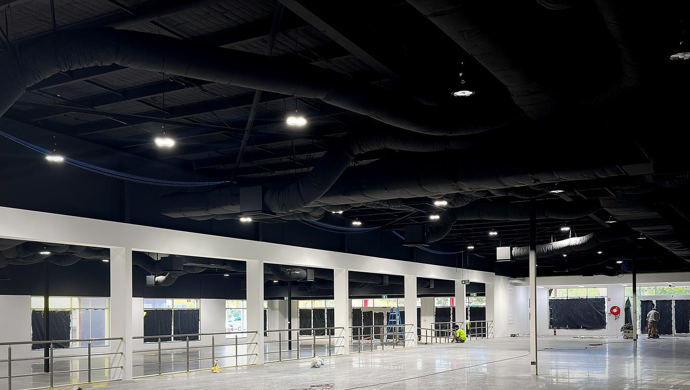 Completed commercial fit-out interior — coated ceiling and polished floor